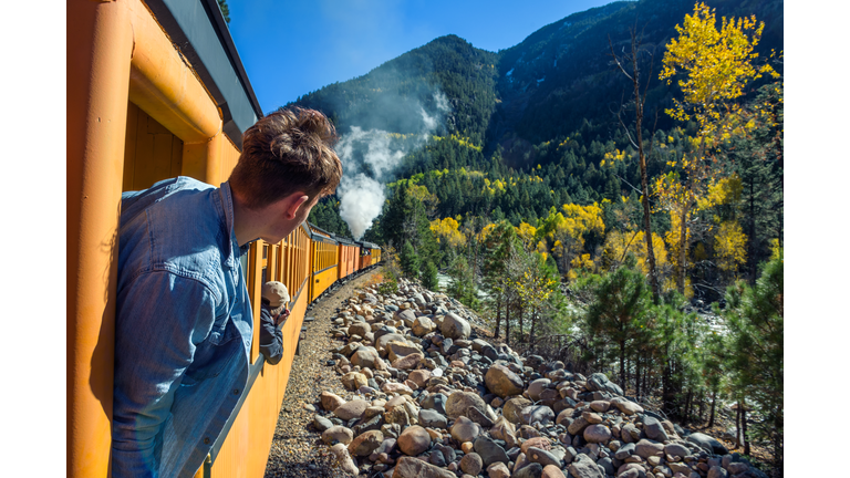 Young man looking out of train window