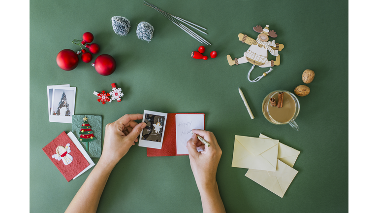 Woman's hands writing Christmas card