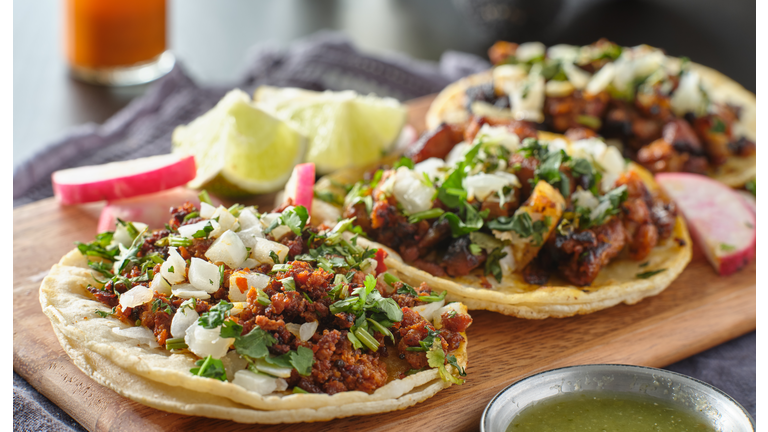 mexican street tacos with carne asada on corn tortillas platter