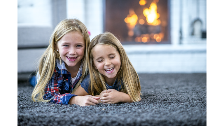 Two Sisters Lying On The Floor