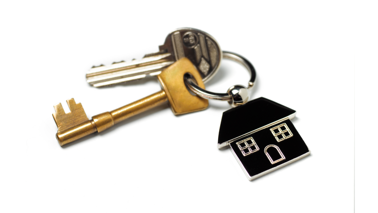 New house, house keys on white