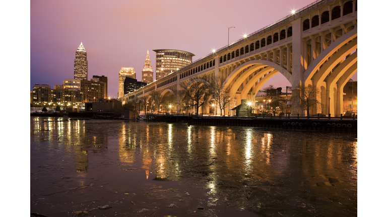 USA, Ohio, Cleveland, Bridge crossing Cuyahoga River at dusk