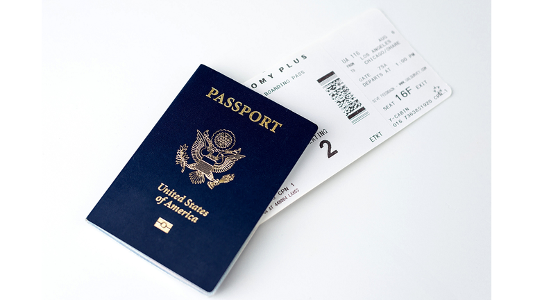 High Angle View Of Passport With Ticket Over White Background