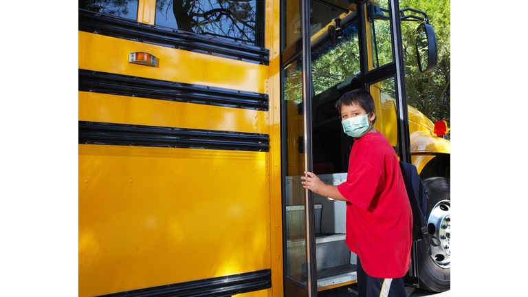 school age boy wearing surgical mask