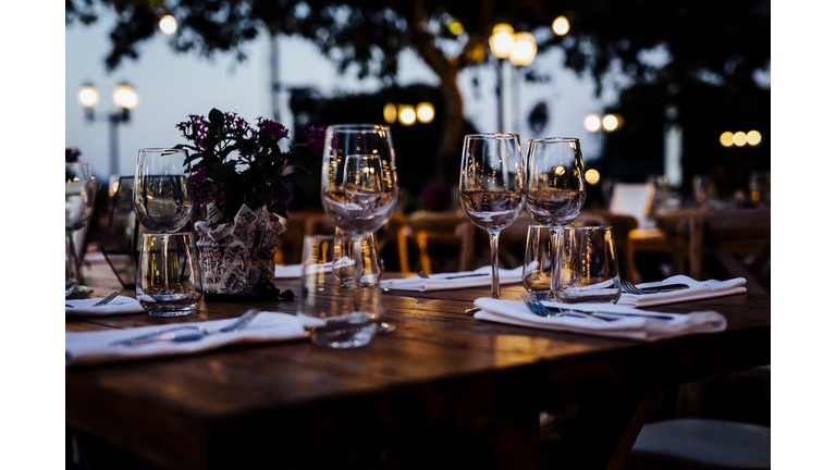 Luxury table settings for fine dining with and glassware, beautiful blurred  background. For events, weddings.