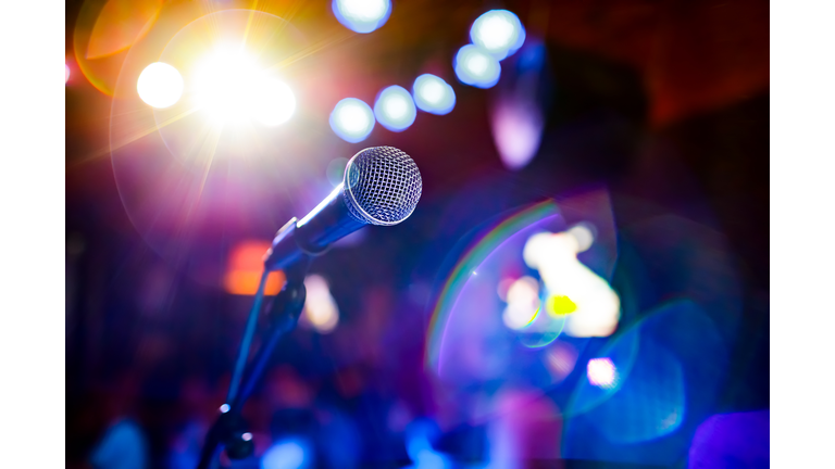 Microphone on stage against a background of auditorium.