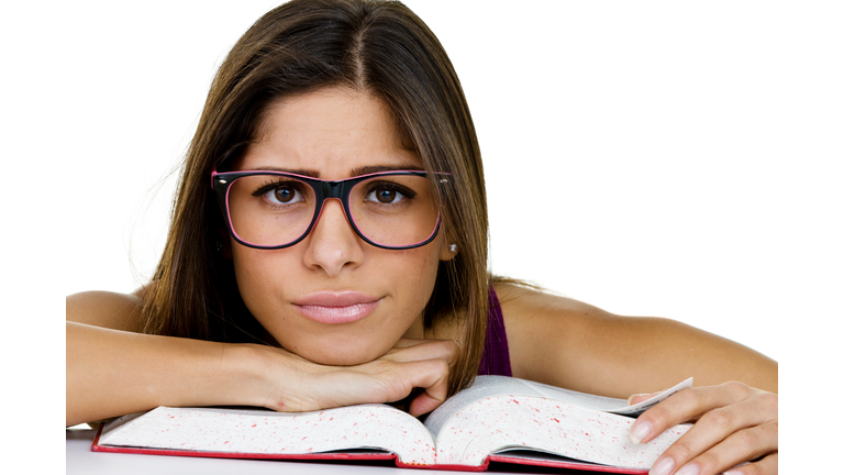 Woman with unhappy expression studying