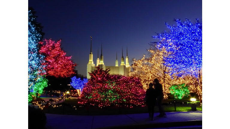 Two People Gazing at the Holiday Lights at The Festival of Lights at the Church of Jesus Christ of Latter Day Saints / Mormon Temple in Kensington Maryland USA