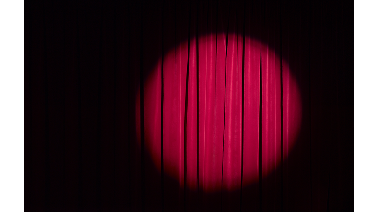 Spot light on red theatre curtains