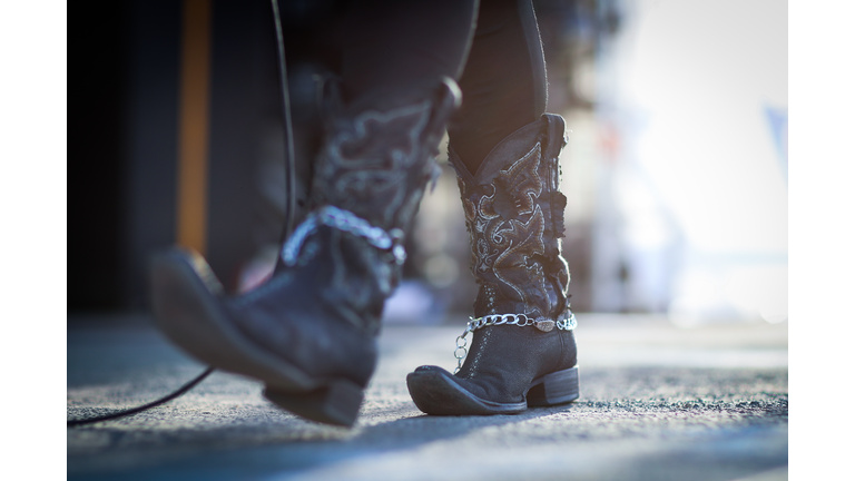 Low Section Of Woman Wearing Cowboy Boots
