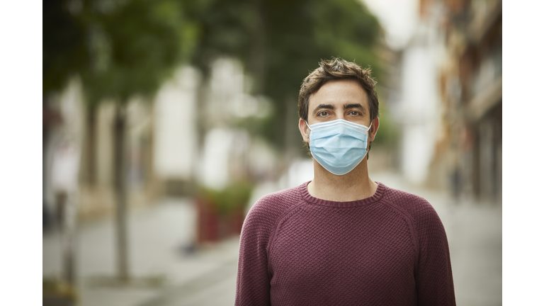 Portrait of a Man in the City Wearing Protective Face Mask