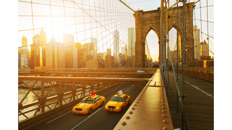 Taxis on The Brooklyn Bridge at sunset in New York