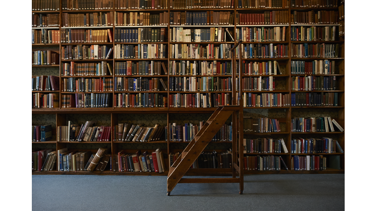 Traditional wooden steps in vintage library.