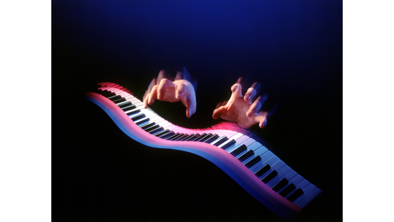 Hands playing flowing keyboard