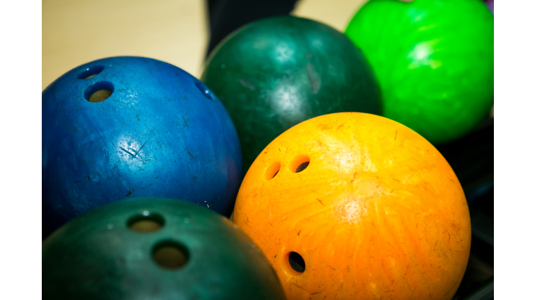 Bowling. Multicolored bowling balls on the shelf in the bowling club.