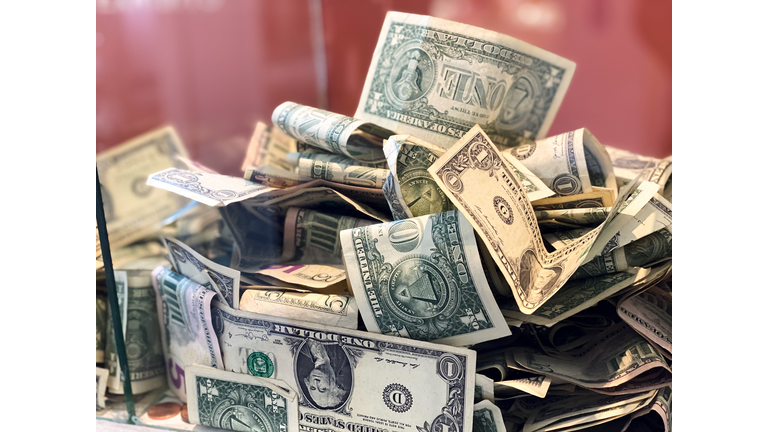 glass donation box with paper currency & coins