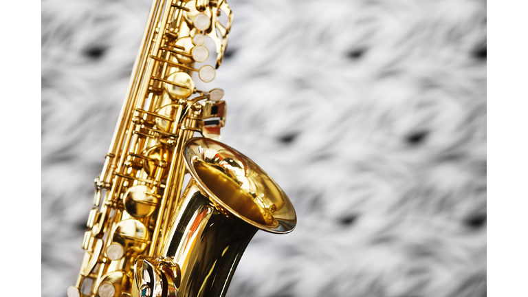 Close up on bell of saxophone against unfocussed bacground