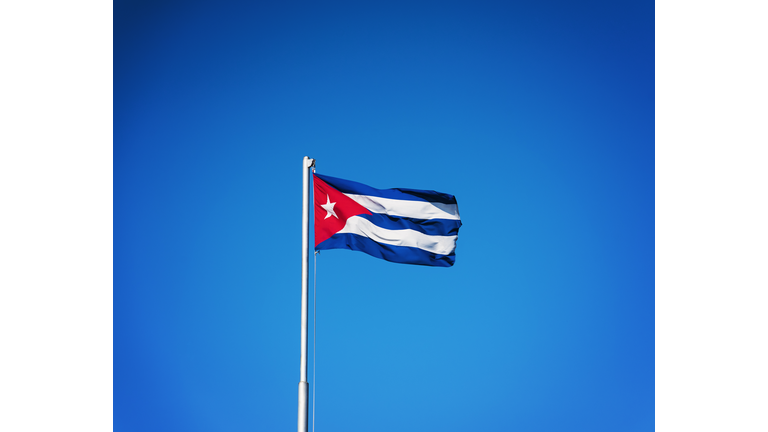 Cuba, Havana, Cuban flag with blue sky