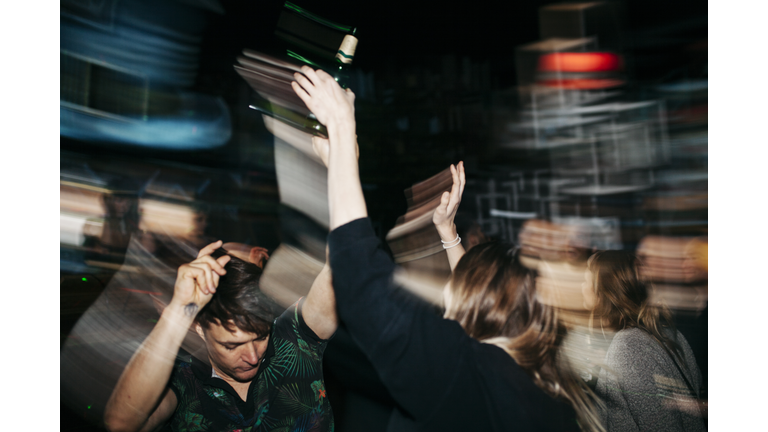 Energetic Scene Of People On Dancefloor At Nightclub