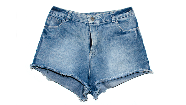 Close-Up Of Denim Shorts Over White Background