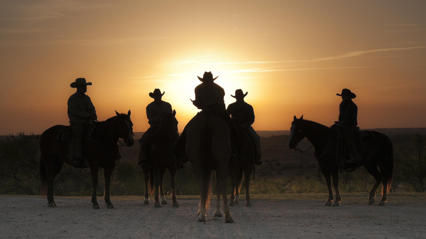 Cowboys and cowgirl at sunrise