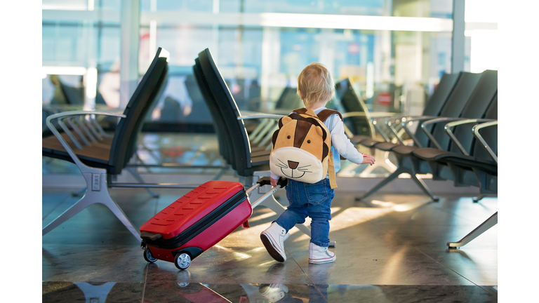 Children, traveling together, waiting at the airport to board the aircraft