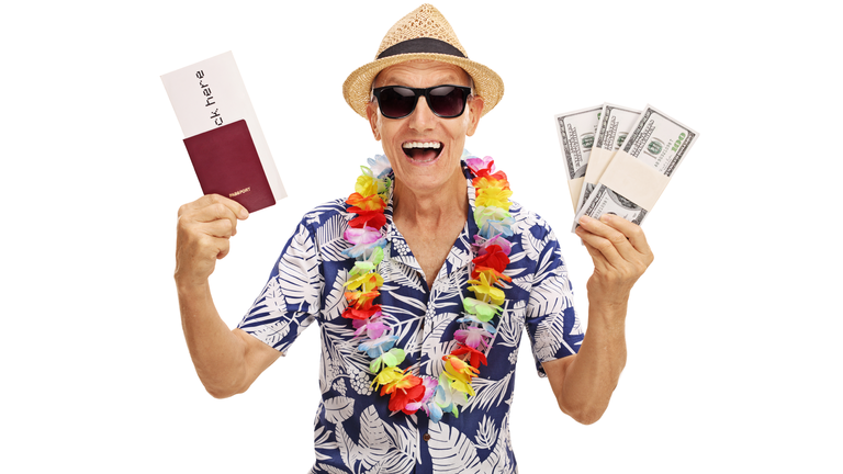 Elderly tourist holding stacks of money