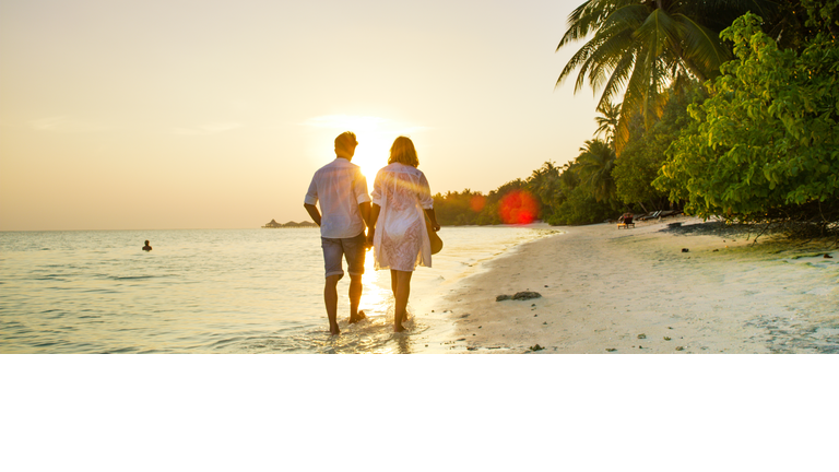 View of pair walking in water,Maldives