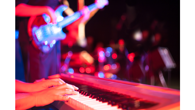 Musician playing on electric keyboard at jazz music festival