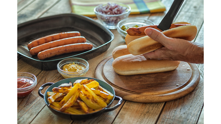 Hot dog preparing, sausage and hotdog bun, close-up