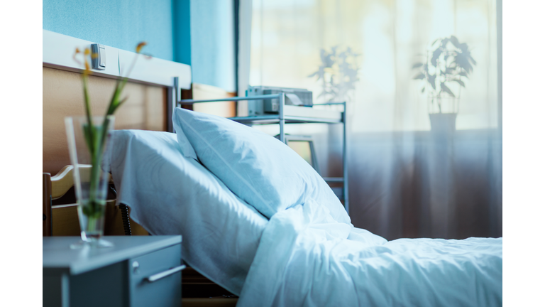 side view of empty hospital bed in clinic chamber