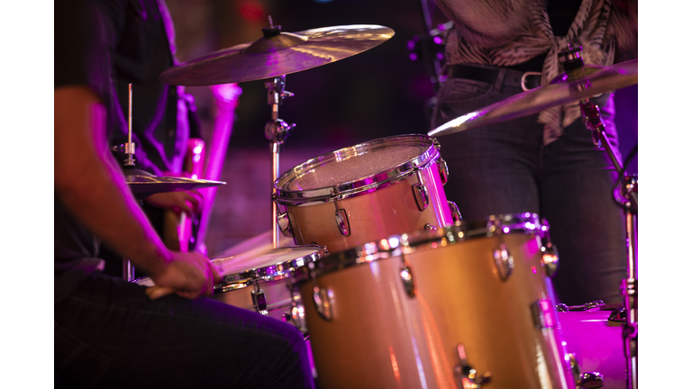 Rock band playing the drums during the concert