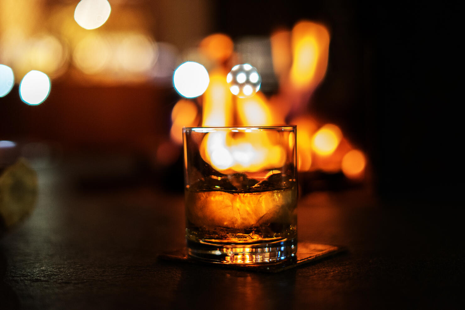 selective focus whiskey glass with bonfire
