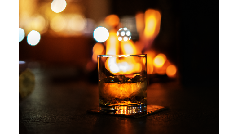 selective focus whiskey glass with bonfire