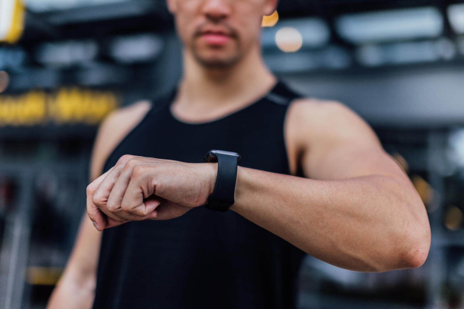 Young Man Checking Time On Smart Watch