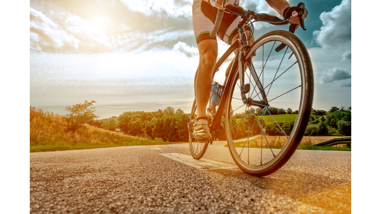 Cyclist rides his bike up a steep hill