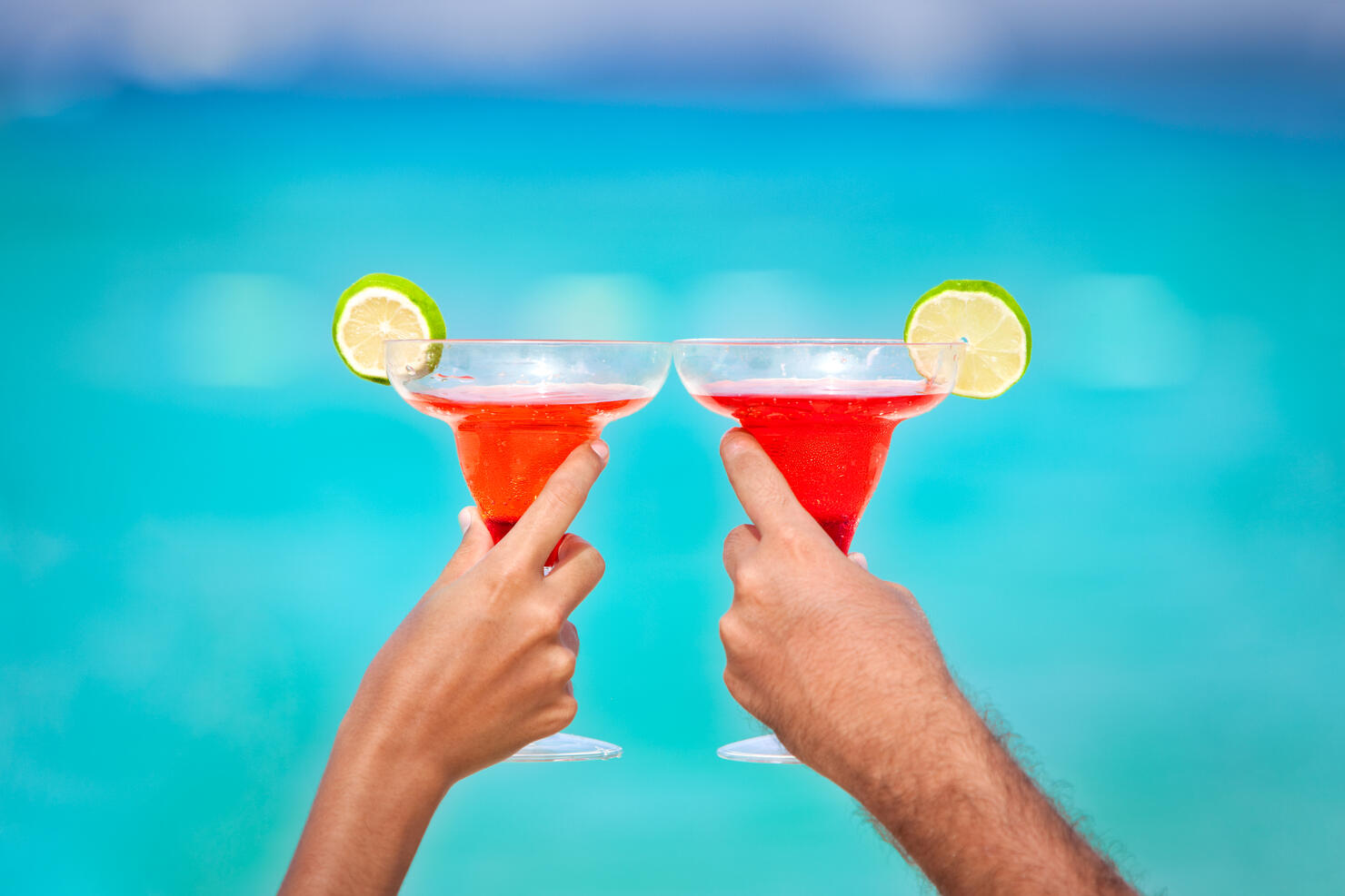 Toasting with Margarita glasses and tropical drinks