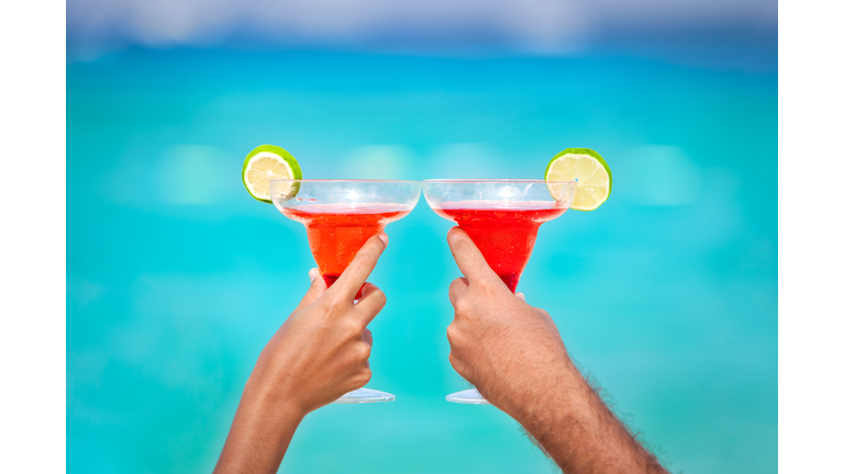 Toasting with Margarita glasses and tropical drinks