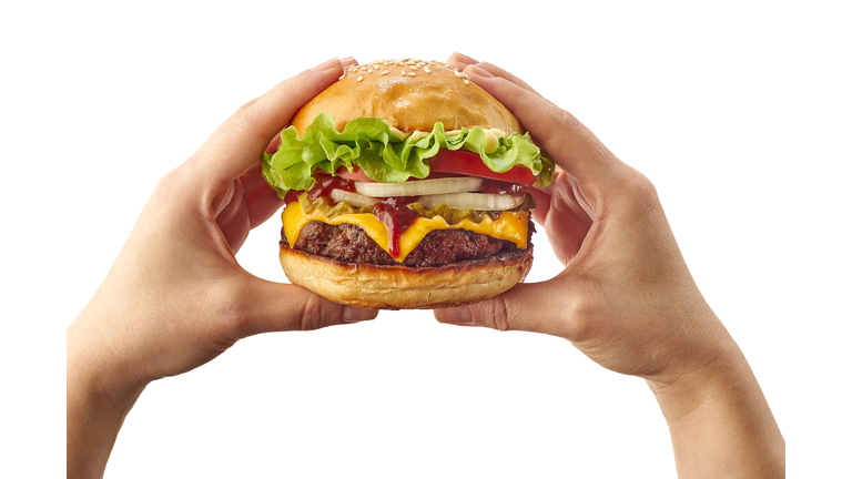 Hands holding hamburger on white