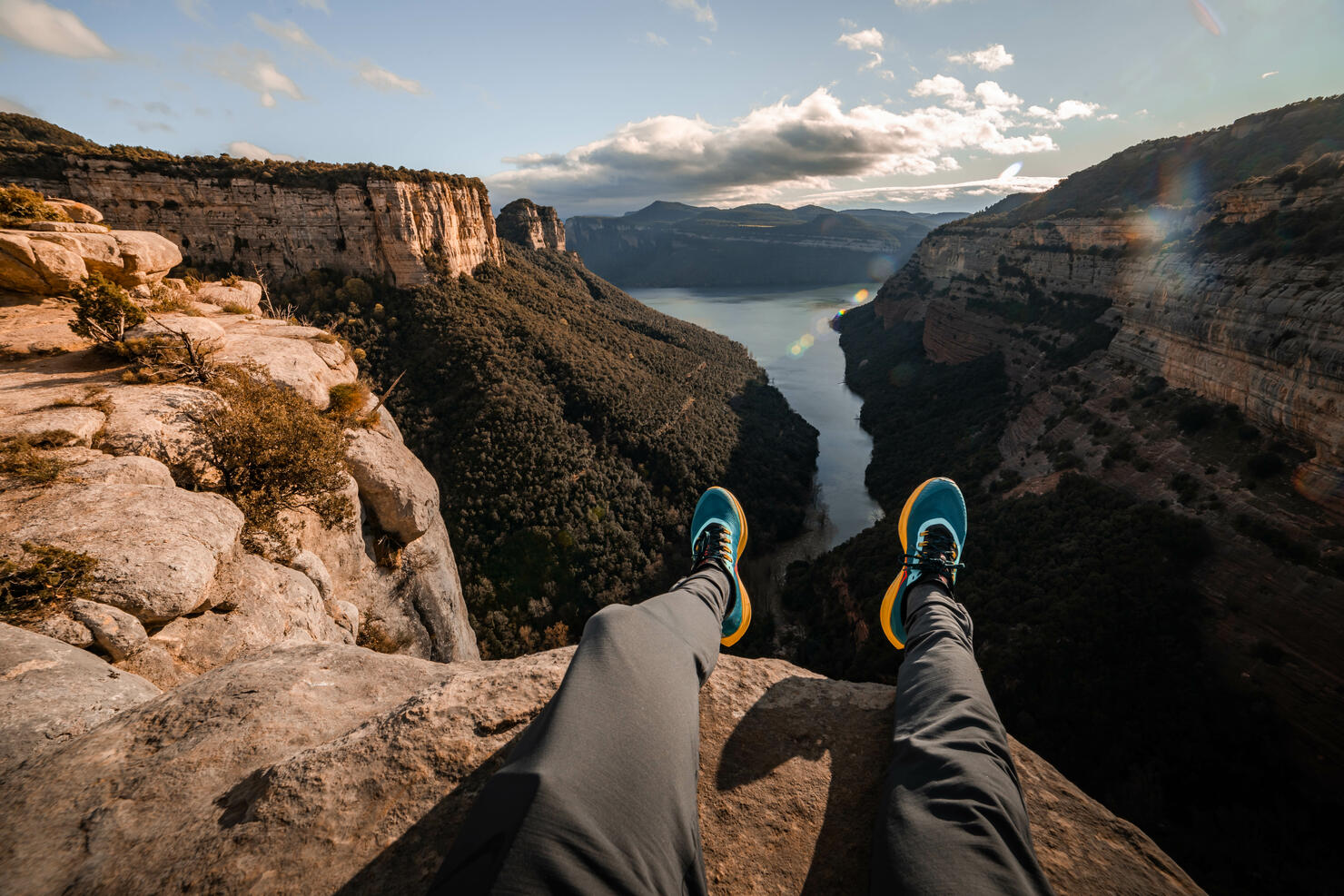 Stunning view from personal perspective in rocky mountains sitting on the edge.