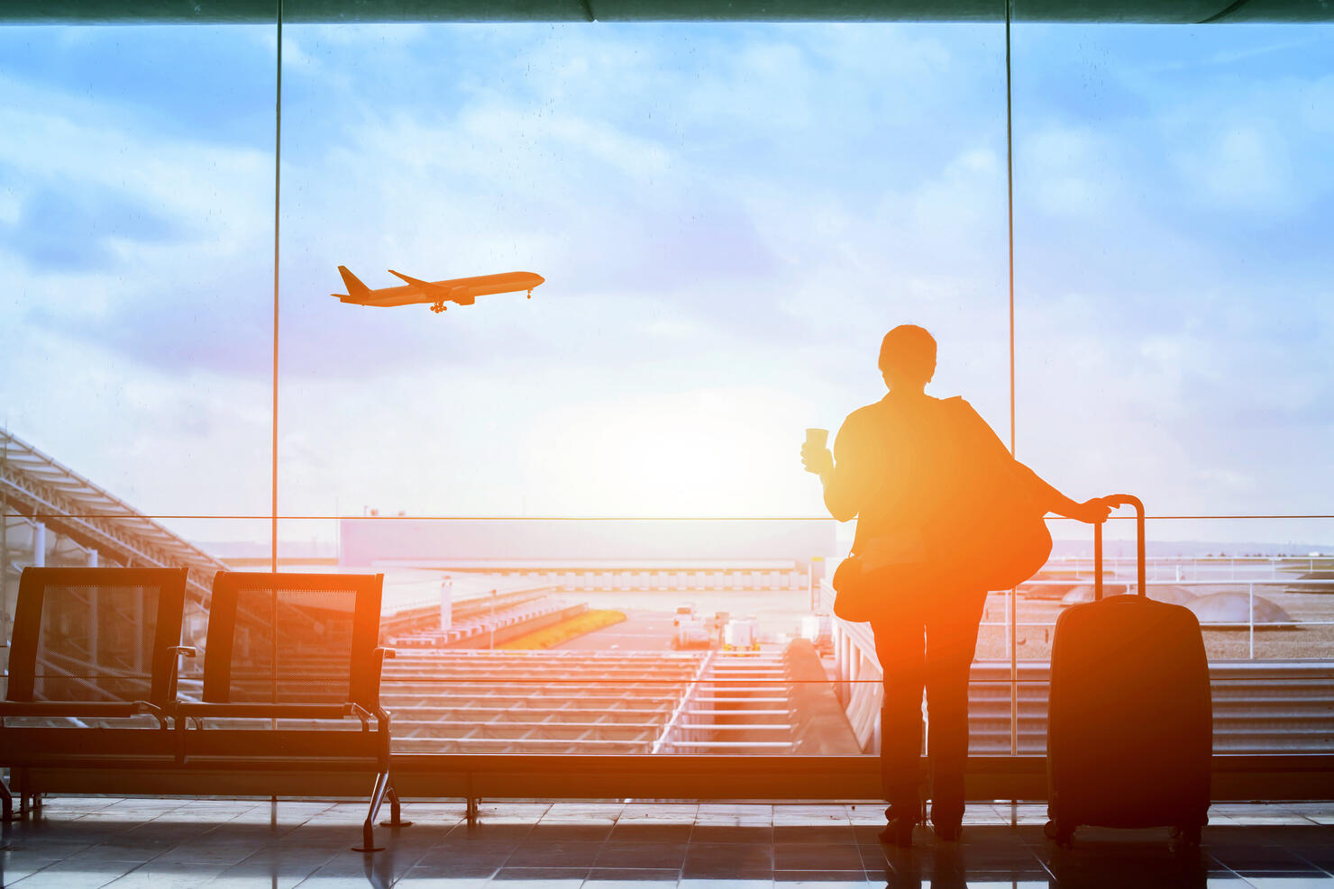 happy traveler waiting for the flight in airport