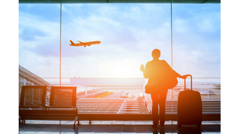 happy traveler waiting for the flight in airport