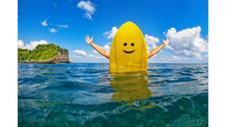 Happy surfer girl sit on yellow surfboard with smiley face