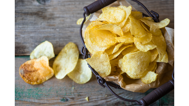 High Angle View Of Fresh Crunchy Potato Chips On Table