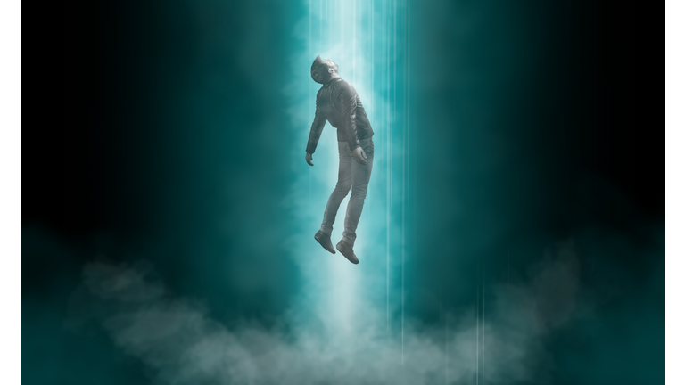 Man being abducted by UFO - alien abduction concept