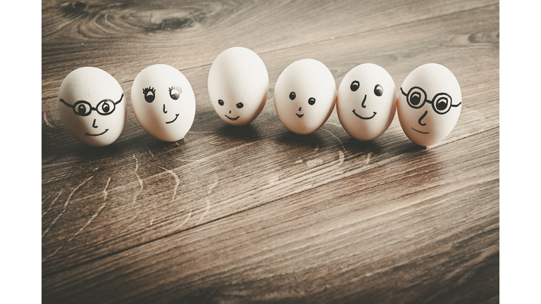 A family of three generations drawn on some eggs. Children, parents, grandparents.. Conceptual nature