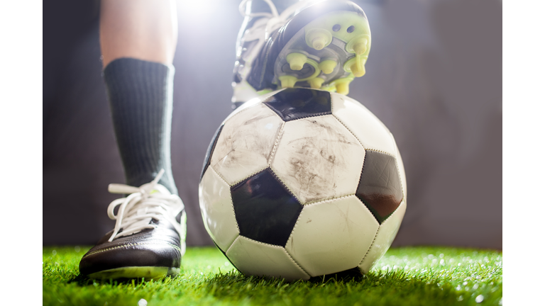 Low Angle View Of Player With Soccer Ball On Field