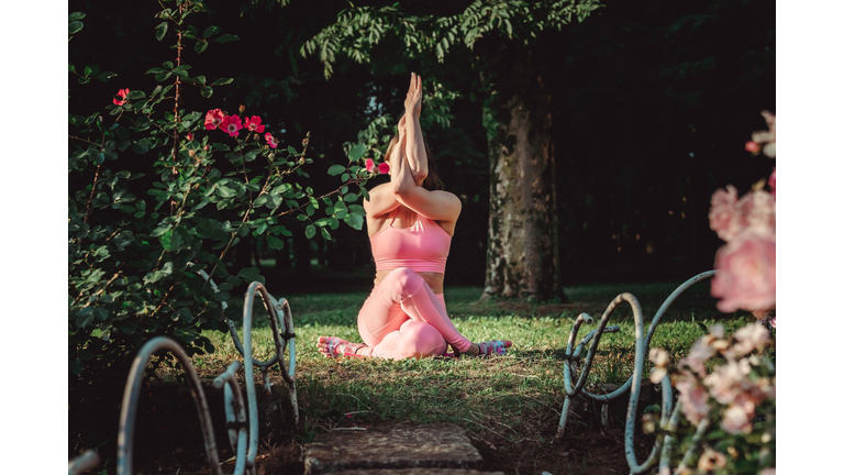 A woman doing outdoor yoga at the park