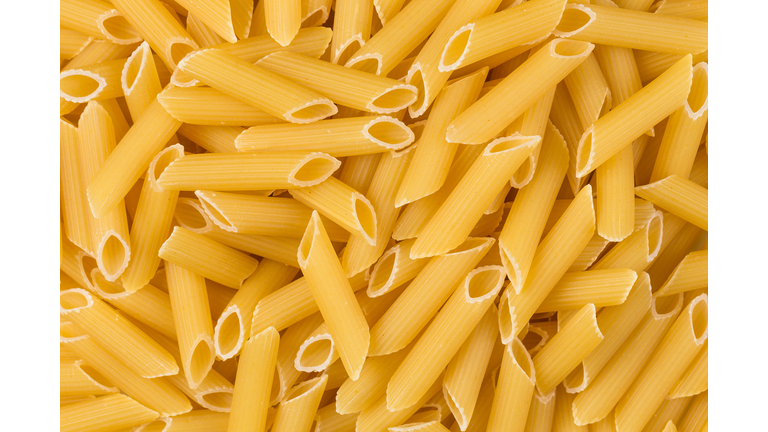 Closeup photo of uncooked italian penne pasta background