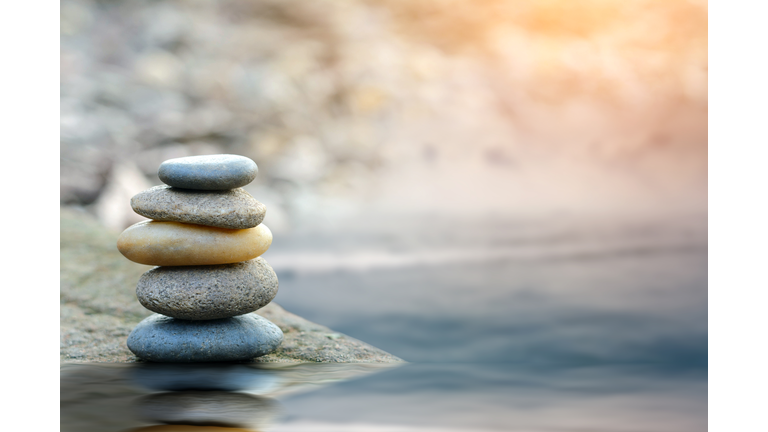 Balance stone with spa on river coast